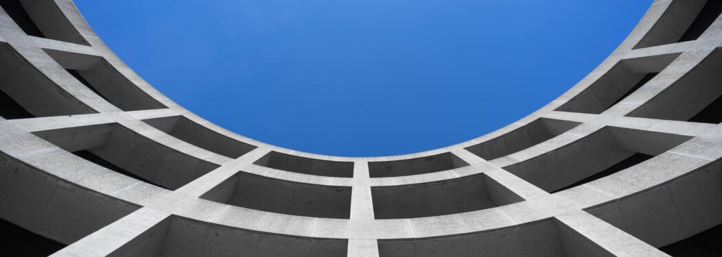 low angle photography of gray concrete building at day time