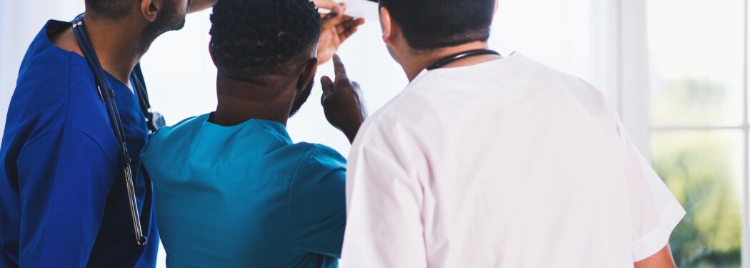 Three Person Looking at X-ray Result