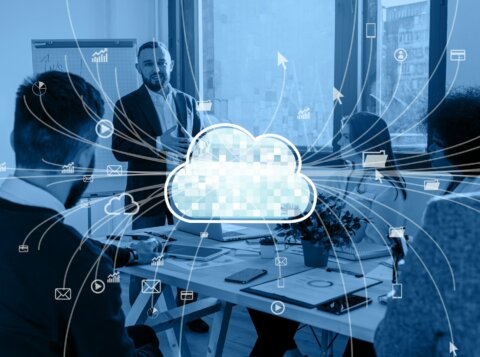 a group of people sitting around a table with a cloud above them